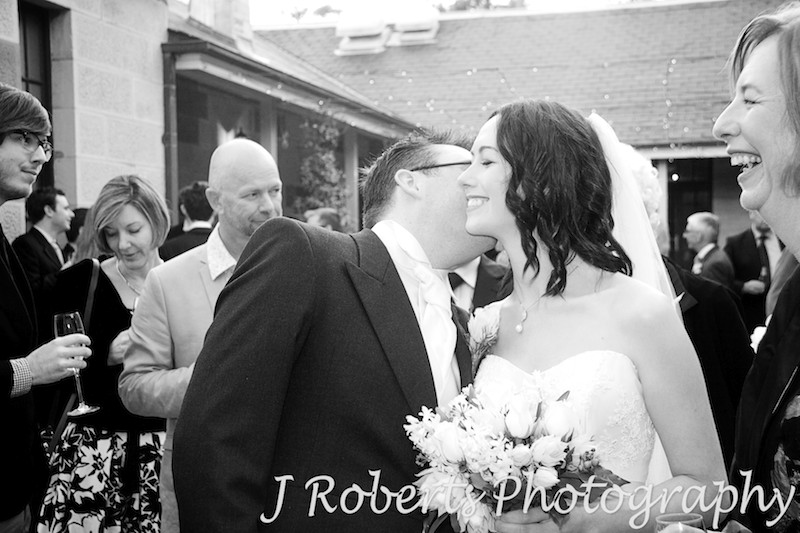 Groom kissing bride following the ceremony - wedding photography sydney